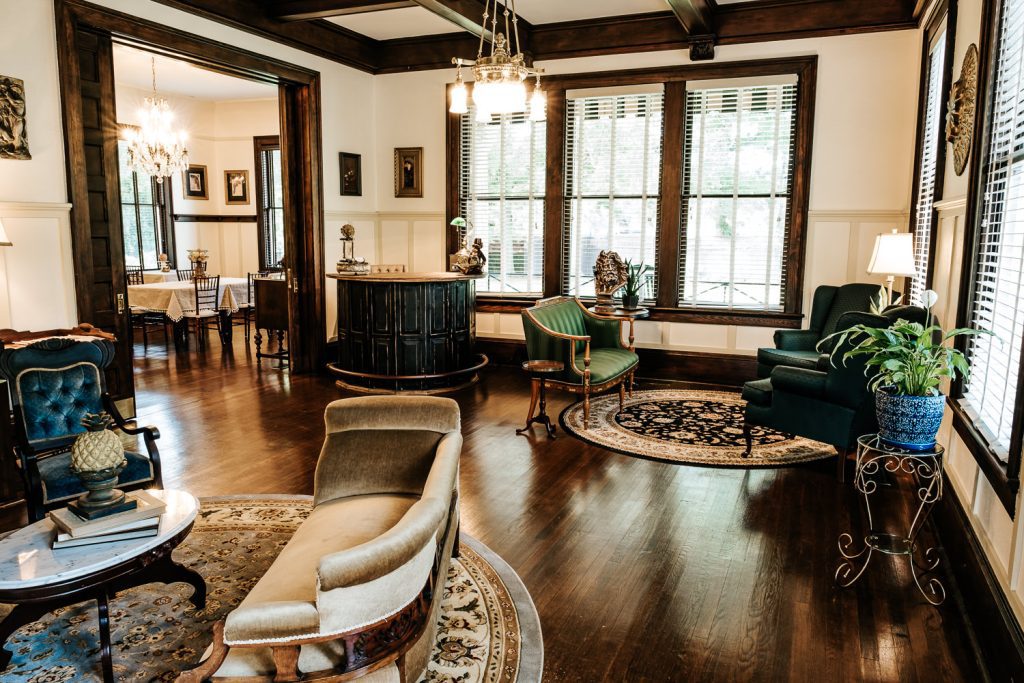 Heritage House lobby in the parlor, showing the front desk and multiple seating areas