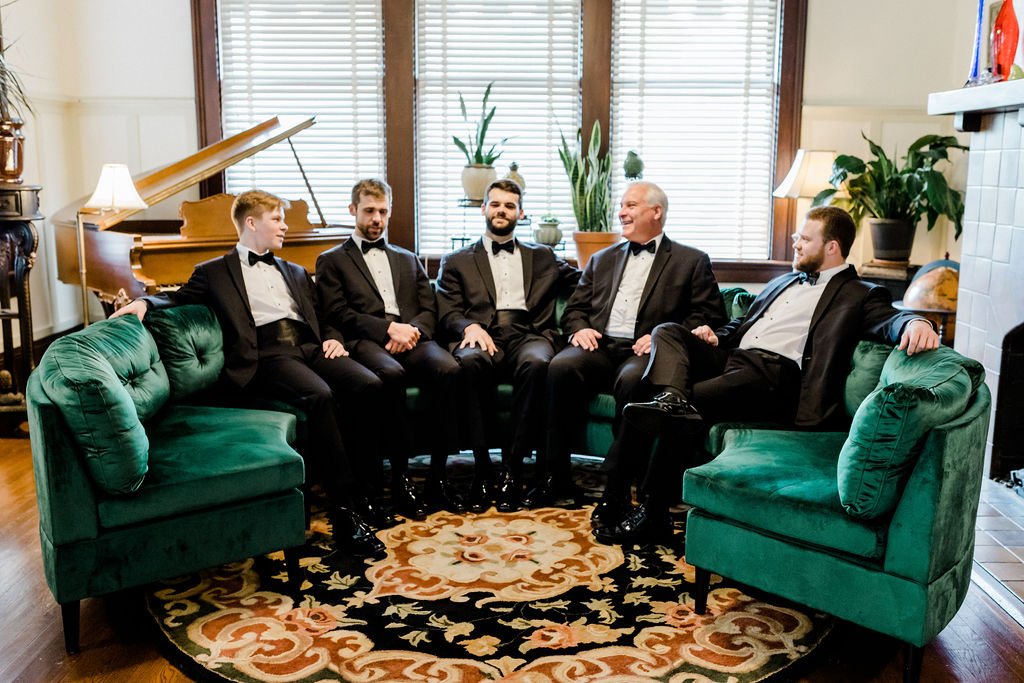 Groom and his groomsmen sitting in the Heritage House parlor
